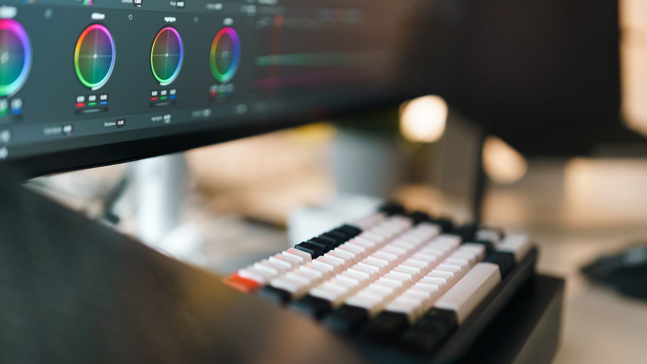 Video editing workspace with a colour-grading panel and keyboard — outsource video editing