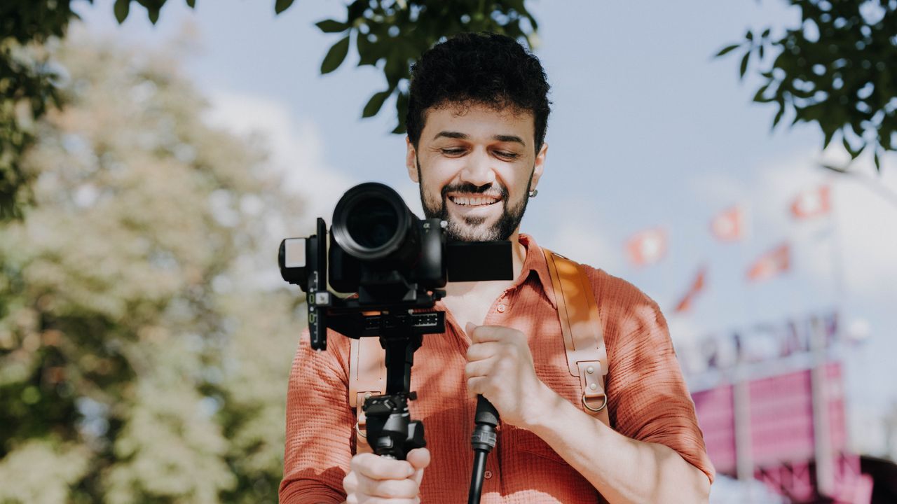 Videographer filming a property with a gimbal-stabilised camera for a real estate video
